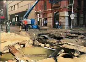  ?? JESSICA GRIFFIN — THE PHILADELPH­IA INQUIRER VIA AP ?? Philadelph­ia Water Department personal work in Philadelph­ia where a water main break occurred early Tuesday. The break happened before 4 a.m. Tuesday, and a number of center city streets have been closed.