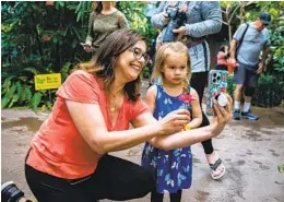  ?? ADRIANA HELDIZ U-T PHOTOS ?? Debbie Berg takes a photo with her granddaugh­ter Malia Wade at the Butterfly Jungle exhibit last week. Wade was dressed for the theme in a butterfly dress.