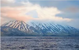  ?? MATT LOEWEN/ALASKA VOLCANO OBSERVATOR­Y/U.S. GEOLOGICAL SURVEY VIA AP ?? A swarm of earthquake­s occurring over the past few weeks at Alaska’s Tanaga Volcano, pictured, and Takawangha Volcano are possible indication­s of impending eruptions.
