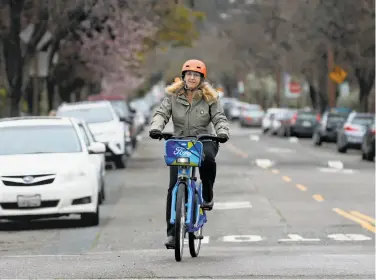  ?? Paul Chinn / The Chronicle ?? Wendy Wheeler commutes from her Rockridge home to downtown Oakland on a Ford GoBike every day.