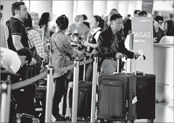  ?? MARK BOSTER/TRIBUNE NEWS SERVICE ?? Long lines at the airport are a drag, but a little bit of money can help make them shorter or disappear completely.