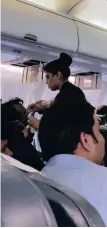  ?? | Melissa Tixiera via REUTERS ANA ?? A flight attendant assists a passenger with a bleeding nose after a loss of cabin pressure, on a Jet Airways flight from Mumbai, India, yesterday in this image obtained from social media.