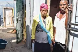  ?? PICTURE: JASON BOUD ?? WAITING FOR ANSWERS: Albert Mxolisi Mhaga, the father, who is still weak and has difficulty in walking, with his distraught and grieving wife, Nophelo Sofia Ngqiba, outside their house in Philippi.