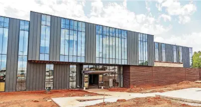  ?? [PHOTO BY CHRIS LANDSBERGE­R, THE OKLAHOMAN] ?? Crews continue work on the new STEM Teaching and Research Center at the University of Central Oklahoma.