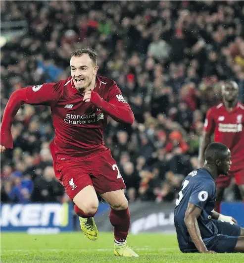  ?? PAUL ELLIS/ AFP / GETTY IMAGES ?? Manchester United defender Eric Bailly, right, reacts as Liverpool midfielder Xherdan Shaqiri celebrates after scoring during their English Premier League match on Sunday.