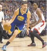  ?? DARRYL DYCK/THE CANADIAN PRESS VIA AP ?? Klay Thompson drives past Toronto’s DeMar DeRozan during Saturday’s exhibition game.