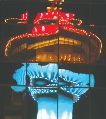  ??  ?? Any night light tour in Calgary needs to start with the iconic Calgary Tower, which looks especially spooky this Halloween when reflected on a building. The tower puts on spectacula­r light shows nightly, with 132 lights used to produce more than 16.5-million effects and colour combinatio­ns.