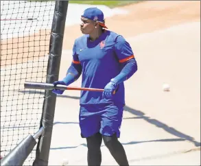  ?? Kathy Willens / Associated Press ?? New York Mets left fielder Yoenis Cespedes emerges from the batting cage during a training camp workout at Citi Field on Thursday.