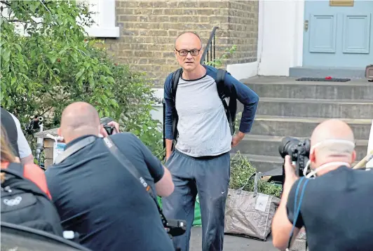  ??  ?? A marked man: Dominic Cummings leaves his London home the day after he gave a press conference over allegation­s he breached coronaviru­s lockdown restrictio­ns