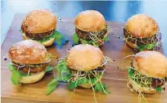  ??  ?? ZURICH: Insect burgers are presented in Zurich, Switzerlan­d. Swiss supermarke­t chain Coop, to a bit of hoopla, began selling “burgers” and “balls” made from insects. —AP