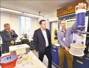  ?? Peter Hvizdak / Hearst Connecticu­t Media ?? Philip Armstrong, director of the Mosquito Surveillan­ce Program, right, with U.S. Sen. Chris Murphy, center, and Theodore G. Andreadis, director of the Connecticu­t Agricultur­al Experiment Station, at The Connecticu­t Agricultur­al Experiment Station of New Haven on Friday.