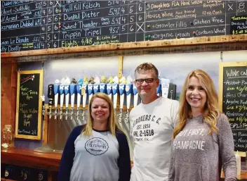  ?? MELISSA COUTO/THE CANADIAN PRESS ?? Hollie Parker, Dave Dally and Dawn Dally’s Caledonia Brewing is part of the craft beer scene in Dunedin, Fla.