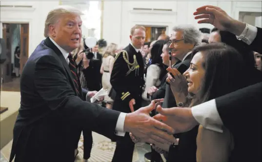  ?? Alex Brandon The Associated Press ?? President Donald Trump shakes hands at a reception for Italian President Sergio Mattarella on Wednesday at the White House. Democrats and Republican­s had criticized Trump’s decision to host next year’s G-7 meeting at Trump National Doral Miami.