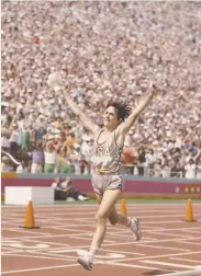  ?? Tony Duffy / Getty Images 1984 ?? Joan Benoit of the United States rejoices inside the L.A. Coliseum after winning the first Olympic women’s marathon at the 1984 Summer Games.