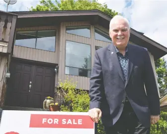  ?? MIKE BELL ?? Realtor John Corrie, seen in front of one of his listed homes on Rockwell Drive in Abbotsford, says the number of offers on homes are down from a few months ago, but the “quality” of them hasn't changed.