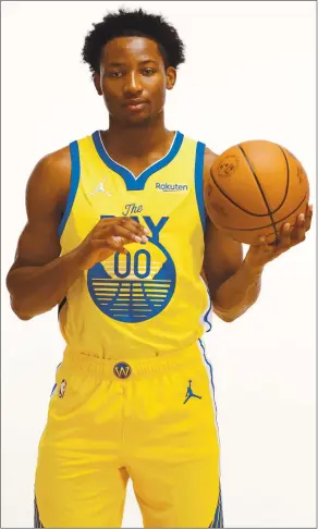  ?? JOE SCARNICI — GETTY IMAGES ?? Jonathan Kuminga poses in his new Warriors uniform during a rookie photo shoot in Las Vegas.