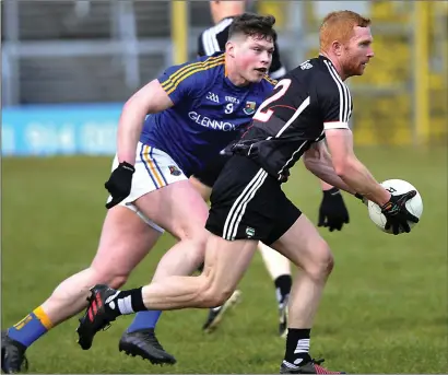  ??  ?? Ross Donovan sets up an attack for Sligo as Longford’s Andrew Farrell tries to intercept. Pic: Tom Callanan.