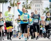  ?? Patrick T. Fallon For The Times ?? RUNNERS IN the L.A. Marathon make their way down Santa Monica Boulevard at the 17th mile.