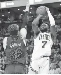  ??  ?? Celtics guard Jaylen Brown shoots over Cavaliers guard Kyle Korver on Sunday.