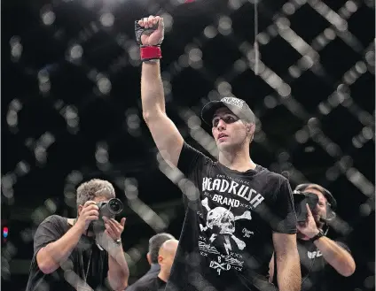  ?? ANDREW VAUGHAN/THE CANADIAN PRESS ?? Rory MacDonald salutes the crowd after defeating Tarec Saffiedine on Oct. 4 in Halifax. MacDonald is bidding to join Georges St-Pierre and Carlos (Ronin) Newton as the only Canadians to hold a UFC championsh­ip title.