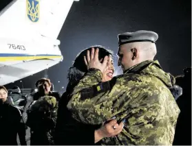  ?? Zoya Shu / Associated Press ?? Yulia embraces her husband, Olexander Korinkov, a Ukrainian soldier and prisoner of war, after he was released in a prisoner exchange on Sunday.