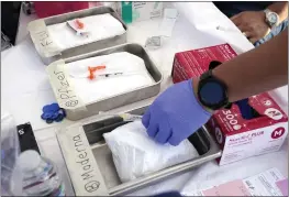  ?? MARK J. TERRILL — THE ASSOCIATED PRESS ?? Syringes with vaccines are prepared at the L.A. Care and Blue Shield of California Promise Health Plans' Community Resource Center in Lynwood on Oct. 28.