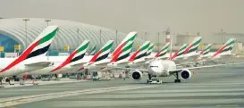  ?? (Bloomberg) ?? Emirates passenger planes lined up at the gates of Dubai Internatio­nal Airport