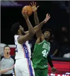  ?? MATT SLOCUM — THE ASSOCIATED PRESS ?? 76ers center Joel Embiid, left, goes up for a shot against the Celtics’ Robert Williams III Tuesday. Embiid scored 18 points in 17 minutes as the Sixers won their preseason opener, 108-99.