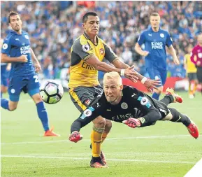  ??  ?? Keeper Kasper Schmeichel beats Alexis Sanchez to the ball.