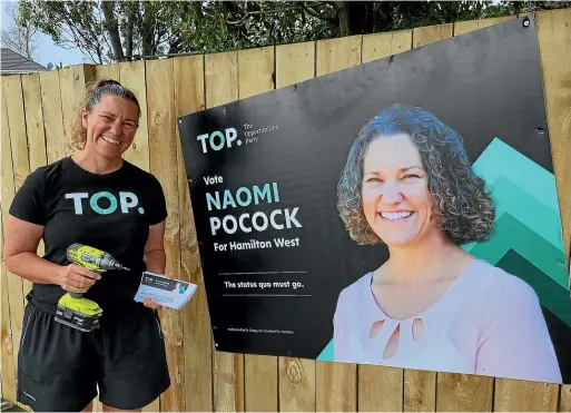  ?? ?? TOP candidate Naomi Pocock, drill in hand, next to one of her slanted hoardings.