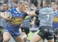  ?? PICTURE: STEVE RIDING ?? SLAP IN THE FACE: Leeds’ Brad Dwyer is stopped in his tracks, unceremoni­ously, by Wakefield’s Ryan Hampshire.