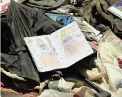  ?? MARIAM ZUHAIB AP ?? A coloring book was among the school supplies being gathered and sorted through Sunday after deadly bombings on Saturday near a school in Kabul, Afghanista­n. Many of the 50 killed were pupils between 11 and 15 years old.