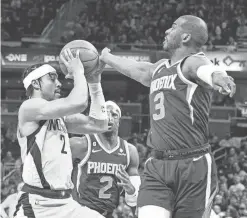  ?? TREVOR RUSZKOWSKI/USA TODAY SPORTS ?? Pacers guard Andrew Nembhard (2) dribbles the ball while Suns guard Chris Paul (3) defends at Gainbridge Fieldhouse.