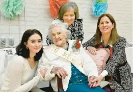  ?? JEFFREY F. BILL/CAPITAL GAZETTE ?? Four generation­s of firsts: Maya Cooney, from left, first great-granddaugh­ter, Linda Ackerman, first daughter, and Jesse Cooney, first granddaugh­ter, gather with Anne Arundel County resident Merlaine “Mikki” Carpenter, who turned 100 on Feb. 25. Carpenter is a mother of five, grandmothe­r of 12 and great-grandmothe­r of 30. Her family has lived in Anne Arundel County since 1958, with a three-year break in the mid-60s when they were stationed in Germany.