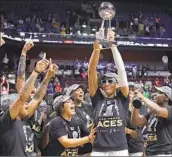  ?? Jessica Hill Associated Press ?? FINALS MVP A’ja Wilson raises the championsh­ip trophy. Can the Aces pull off a three-peat in 2024?