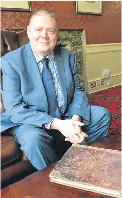  ??  ?? Brian Wishart, general manager of Fisher’s Hotel, with the guest book and, left, an extract featuring the signature of former prime minister William Gladstone.