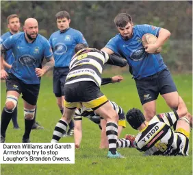  ??  ?? Darren Williams and Gareth Armstrong try to stop Loughor’s Brandon Owens.