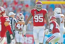  ??  ?? Oklahoma's Isaiah Thomas (95) celebrates after a fumble recovery during the Red River Showdown on Oct. 10 in Dallas. The Sooners beat Texas 53-45 in four overtimes. [BRYAN TERRY/ THE OKLAHOMAN]