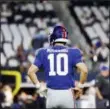  ?? MICHAEL AINSWORTH - THE ASSOCIATED
PRESS ?? New York Giants quarterbac­k Eli Manning (10) warms up before an NFL football game against the Dallas Cowboys in Arlington, Texas, Sunday.