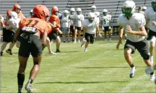  ?? PHOTO/RON HARAMIA ?? Bremen’s Austin Young (right) pursues a Wabash receiver during a scrimmage this summer.