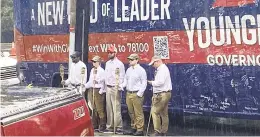  ?? ELIZABETH HOLMES/AP ?? In this image provided by NBC29, five people holding tiki torches stand by the campaign bus for GOP gubernator­ial candidate Glenn Youngkin in Charlottes­ville on Friday. The anti-Donald Trump group The Lincoln Project is taking credit for the stunt.