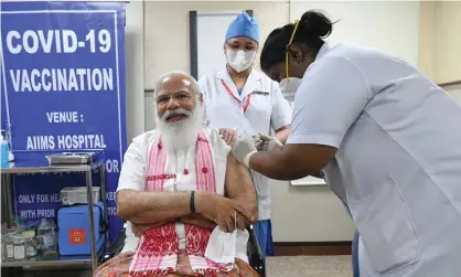  ?? Photograph: AP ?? The Indian prime minister, Narendra Modi, receives his Covid vaccine in New Delhi in March.