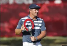  ?? CARLOS OSORIO — THE ASSOCIATED PRESS, 2020 ?? Bryson DeChambeau holds the Rocket Mortgage Classic trophy at Detroit Golf Club in Detroit on July 5. The PGA Tour event is staging a fourday event this year to create more playing and business opportunit­ies in golf for Blacks.