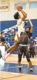  ?? DAVID GARRETT/ SPECIAL TO THE MORNING CALL ?? Executive Education’s Jeremiah Bembry goes over the top of Imhotep’s Rahmir Barno on Saturday.