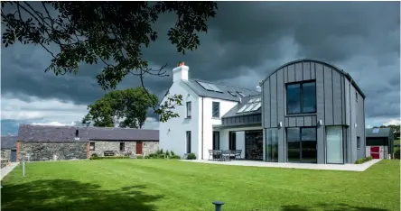  ??  ?? Left: This contempora­ry new build farmstead was designed by
Des Ewing Residentia­l Architectu­re.
The new accommodat­ion was laid out around an existing stone outbuildin­g. Featuring a curved roof, the metal-clad abode has a distinctly agricultur­al aesthetic