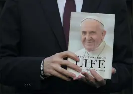  ?? GREGORIO BORGIA — THE ASSOCIATED PRESS ?? Italian journalist and writer Fabio Marchese Ragona holds a copy of “Life: My Story Through History” in Rome on Thursday.