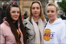  ??  ?? Kimberley Braid, Stacey and Lynsay Grimshaw in Glasgow’s George Square, while top, Holly Brown, 4, places one of her soft toys with the floral tributes