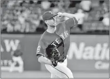  ?? AP/TONY GUTIERREZ Texas Rangers’ Mike Minor (23) works against the Seattle Mariners in the fourth inning of a baseball game Monday in Arlington, Texas. ??