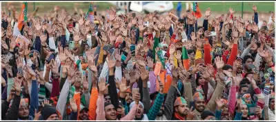  ?? (AP/Rajesh Kumar Singh) ?? Supporters of India’s ruling Bharatiya Janta Party cheer Saturday as they listen to Adityanath during an election rally in Muzaffarna­gar, India.