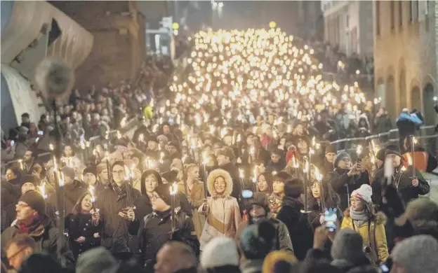  ?? ?? ↑ The torchlight procession will be returning as part of the city’s revived Hogmanay festival, though it will have fewer participan­ts and a longer running time